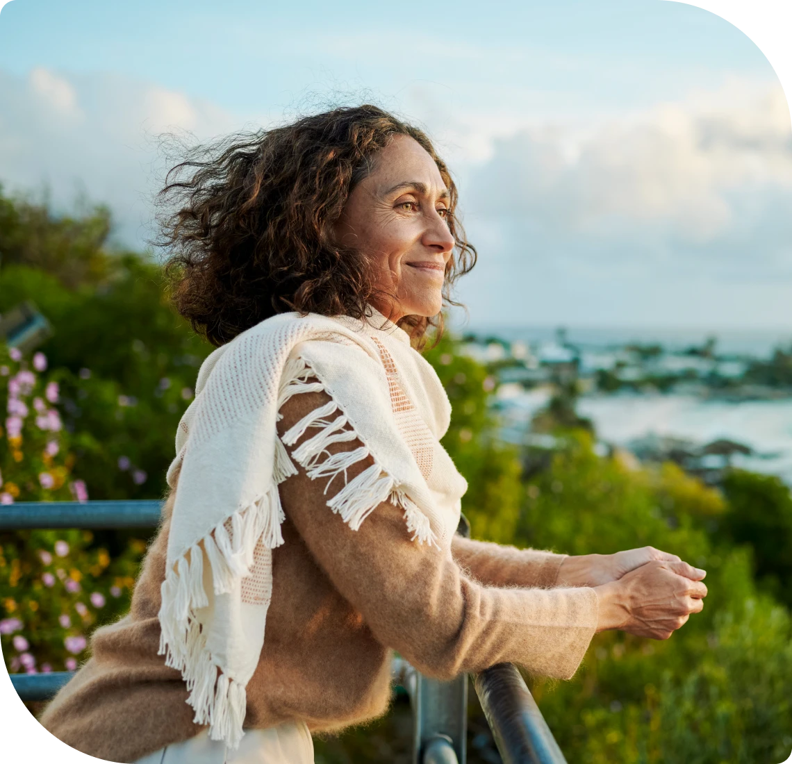 Smiling woman with curly hair outdoors